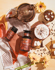 S'mores Loose Leaf Dessert Herbal Tea Top Down on a Table with Graham Crackers, Marshmallows, Chocolate, Loose Leaf tea, and a silk scarf as well as a copper tea pot