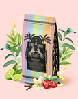 A vibrant coffee bag adorned with palm trees and playful text is surrounded by illustrated lime slices, strawberries, vanilla, and leaves on a light pink background—capturing the refreshing essence of our Strawberry Daiquiri: Green Berry Mocktail Tea for Beautiful, Hydrated Skin from Within. Perfect for summer tea lovers, this lively design showcases the colorful ingredients in our organic green tea blend.