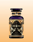 A dark glass bottle labeled "Summer Fridays™: Mai Tai" with gold details, palm trees, and parrots on the label sits against a peach gradient background. The bottle contains a refreshing zero-proof black tea mocktail inspired by the classic Mai Tai.