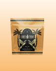 A tan, resealable tea pouch labeled "Summer Fridays™: Mai Tai," with palm trees and parrots, creates a zero-proof cocktail vibe on a gradient peach background.