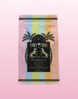 The pastel rainbow package of Summer Fridays™: Rose All Day displays palm trees, leopards, and gold borders on a pink gradient—an alcohol-free rosé alternative with a tropical fruit blend.