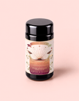 A black tea canister labeled “Tea for Adventure: Horchata Chai: Spiced Yerba Mate” with colorful artwork, described as a spiced adaptogen yerba mate horchata chai blended with Mexican vanilla bean, on a soft pink background.
