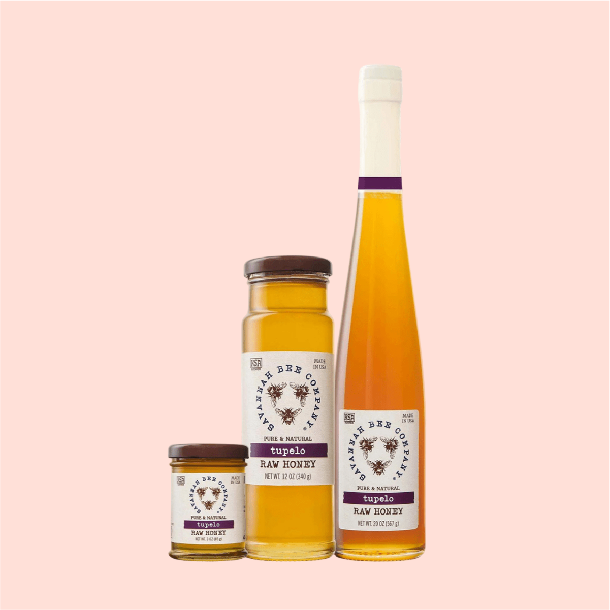 Three Savannah Bee Co. Honey - Tupelo jars from the Apalachicola River Basin sit on a light pink background. The smallest jar is open, the medium jar is closed, and the tallest bottle has a corked long neck. Each label showcases an intricate honey bee illustration.