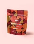 A resealable bag labeled "S'mores: Chocolate Herbal Dessert Tea for the Kid in All of Us" features organic rooibos in a caffeine-free blend, with an orange, red, and brown geometric pattern on light pink.