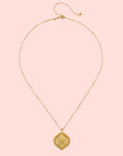 An 18” necklace featuring a delicate gold chain with small beads and a detailed, diamond-shaped white topaz lotus medallion pendant adorned with intricate floral patterns.