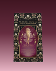 A beautifully designed tea package labeled "Aphrodite's Alchemy: Damiana & Rose White Tea," featuring an illustrated goddess of love from Greek mythology, surrounded by flowers and elegant gold accents.