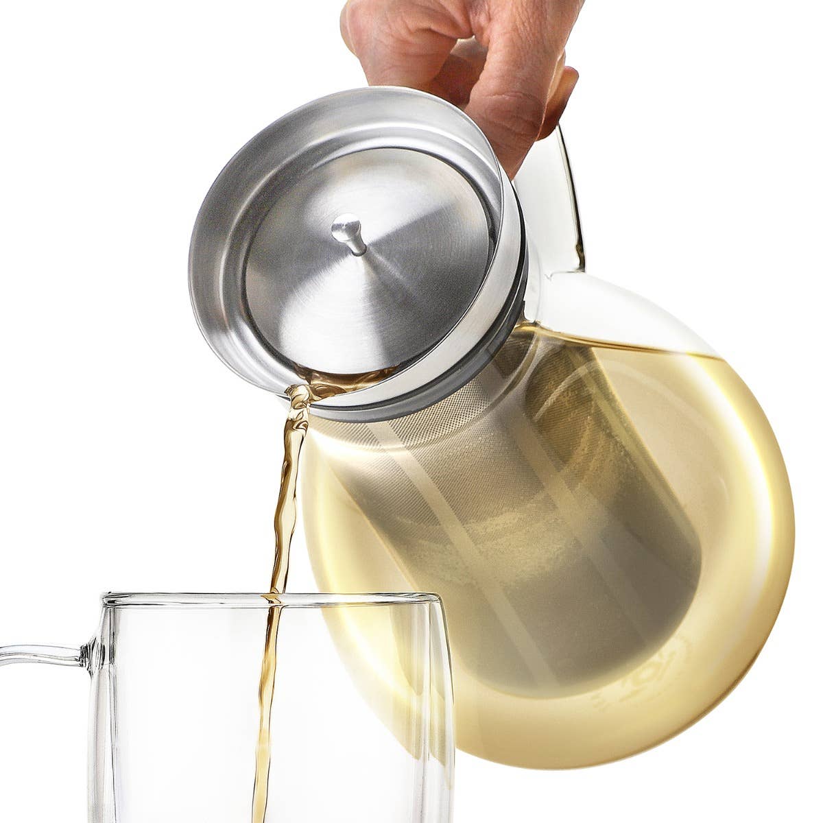 A hand pours tea from the Teabloom Solstice Multi-Brew Glass Tea Pitcher with a lid into a clear glass cup.