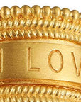 Close-up of the Inner Light I Am Loved Spinning Ring, gold plated with detailed beading and "I AM LOVED" engraved on a smooth band, symbolizing unconditional love.