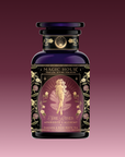 A beautifully designed tea package labeled "Aphrodite's Alchemy: Damiana & Rose White Tea," featuring an illustrated goddess of love from Greek mythology, surrounded by flowers and elegant gold accents.