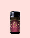 A Monthly Magic Tea Journey Subscription featuring “She Rises: Lakshmi in Abundance, Crème Rose Black Tea” arrives in a beautifully designed jar adorned with ornate artwork of a woman surrounded by lotus flowers on a soft pink background—perfect for goddess ritual tea or exploring the Divine Feminine.