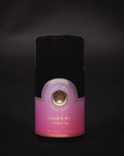 A cylindrical, black metal container of Magic Hour Drift into Sleep Ritual Gift against a dark background. The label at the bottom features a gradient from deep pink to light pink, with gold lettering and a circular logo in the center.