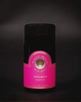 A black cylindrical tin labeled "Magic Hour Blissful Black Teas Medley" with a pink and gold design against a dark background. Featuring Organic Loose Leaf Tea, the label includes a circular logo with a tree and the text "Time for Infusion." The net weight is listed as 1 oz (28g).