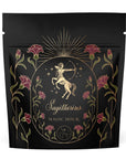 A black, resealable bag features a gold-etched design of a centaur archer, symbolizing Sagittarius, surrounded by red carnations and green leaves. The text "Sagittarius Tea of Good Fortune & Abundance" appears below the centaur, with a celestial motif at the bottom of the design. Enjoy your organic loose leaf tea during this Magic Hour experience.