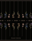 A black background features symmetrical floral patterns arranged in vertical lines. The flowers, in shades of red, blue, purple, and white with green stems and leaves, evoke the essence of organic tea gardens. Small stars are scattered across, and "Tea Ceremony Towels Bundle by Magic Hour" is written in gold at the bottom center.