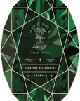 An image of the Magic Hour Front Jar Label, designed to resemble a green emerald gemstone package. The label features "Magic Hour" prominently in the center with "Time for Infinity" beneath a celestial hourglass graphic. Additional text reads: "Ceremonial Teas," "Made with Love," and "Gemstone Wellness Tea." It has the elegant appearance of a reincarnated, stand-alone gold foil front jar label.