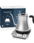 A silver gooseneck electric kettle with a black handle sits on a digital base displaying a temperature of 195°F, perfect for brewing loose leaf tea. The Electric Pour Over Kettle is placed in front of its product box, labeled with "Magic Hour" and "0.8L.
