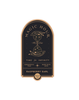 The Magic Hour Front Jar Label showcases a stand-alone gold foil design featuring an hourglass with stars and planets. Text on the label includes "Time for Infinity," "Ceremonial Teas," "Made with Love," and "White Tea." The elegant design is further enhanced by its arched border.