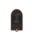 A stylized front jar label for the Magic Hour herbal tea brand, rendered in elegant black and gold foil, features an hourglass at its center dispersing stars. The label reads: "Magic Hour Front Jar Label: Time for Infinity, Ceremonial Teas Made with Love, Rise & Shine." This design evokes a sense of elegance and sophistication.