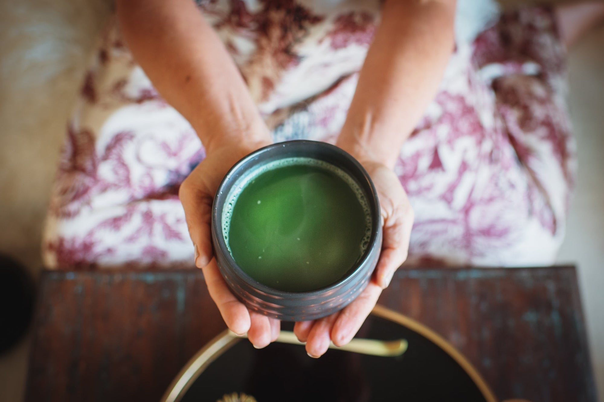 Female holding a ceremonial bowl of matcha