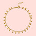 The Joyful Anklet is a delicate 18k gold plated anklet with small dangling gold beads spaced along a fine oval cable chain, finished with an adjustable clasp.