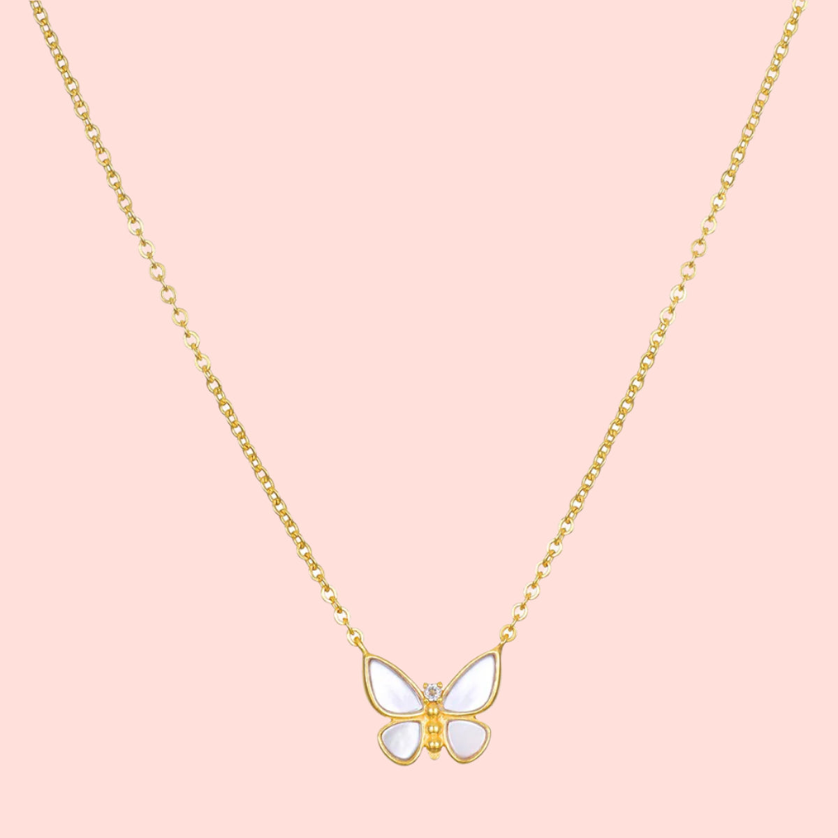 The Renewed Hope Pearl Butterfly Necklace features a gold chain and a delicate butterfly pendant with white enamel wings, crafted in 18k gold plated metal, displayed on a plain white background.