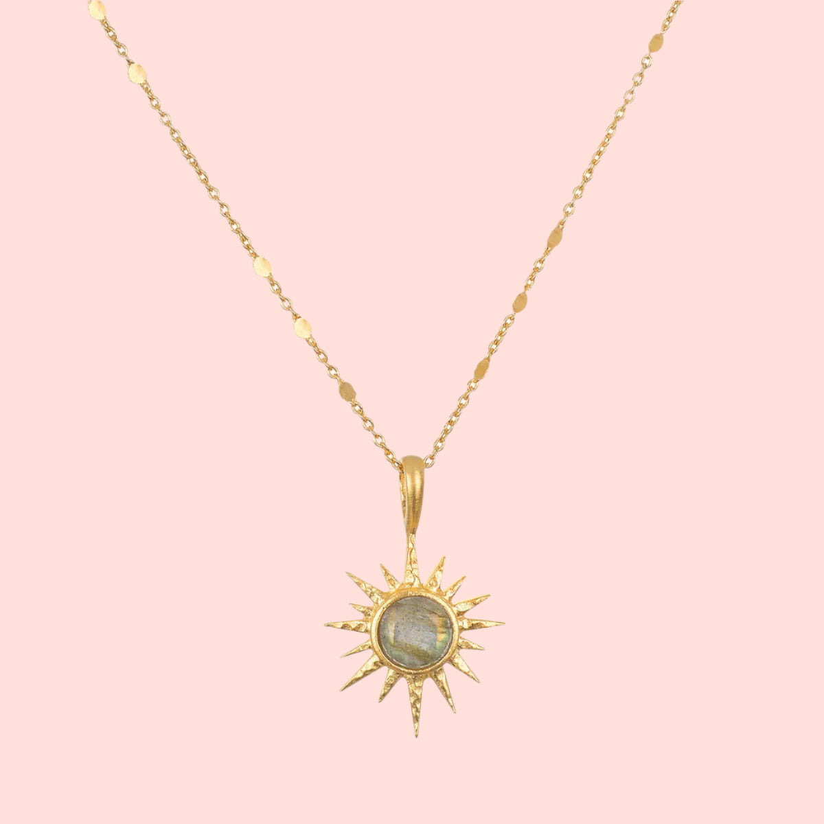 The 16" Labradorite North Star Necklace features a delicate chain and a sun-shaped pendant with a round, iridescent labradorite stone at the center.