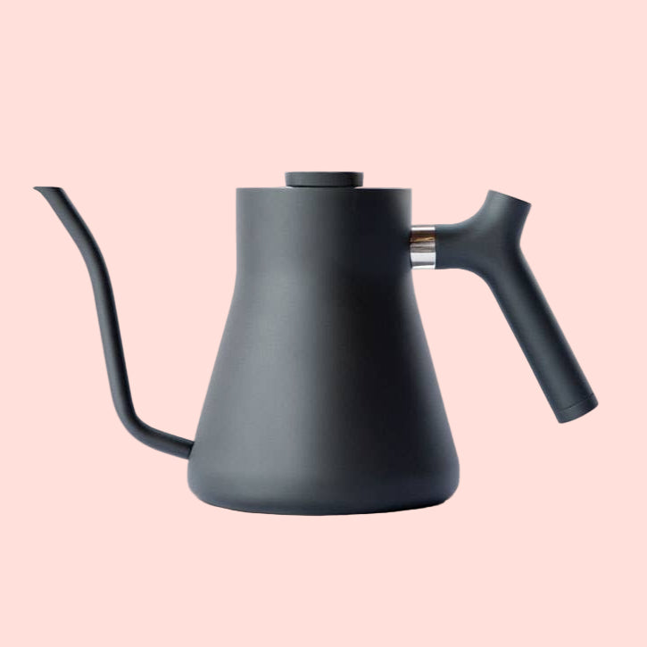 The Stagg Pour-Over Kettle (Stovetop) is a matte black kettle with a minimalist design, precision pour spout, and angled handle, shown against a plain white background.