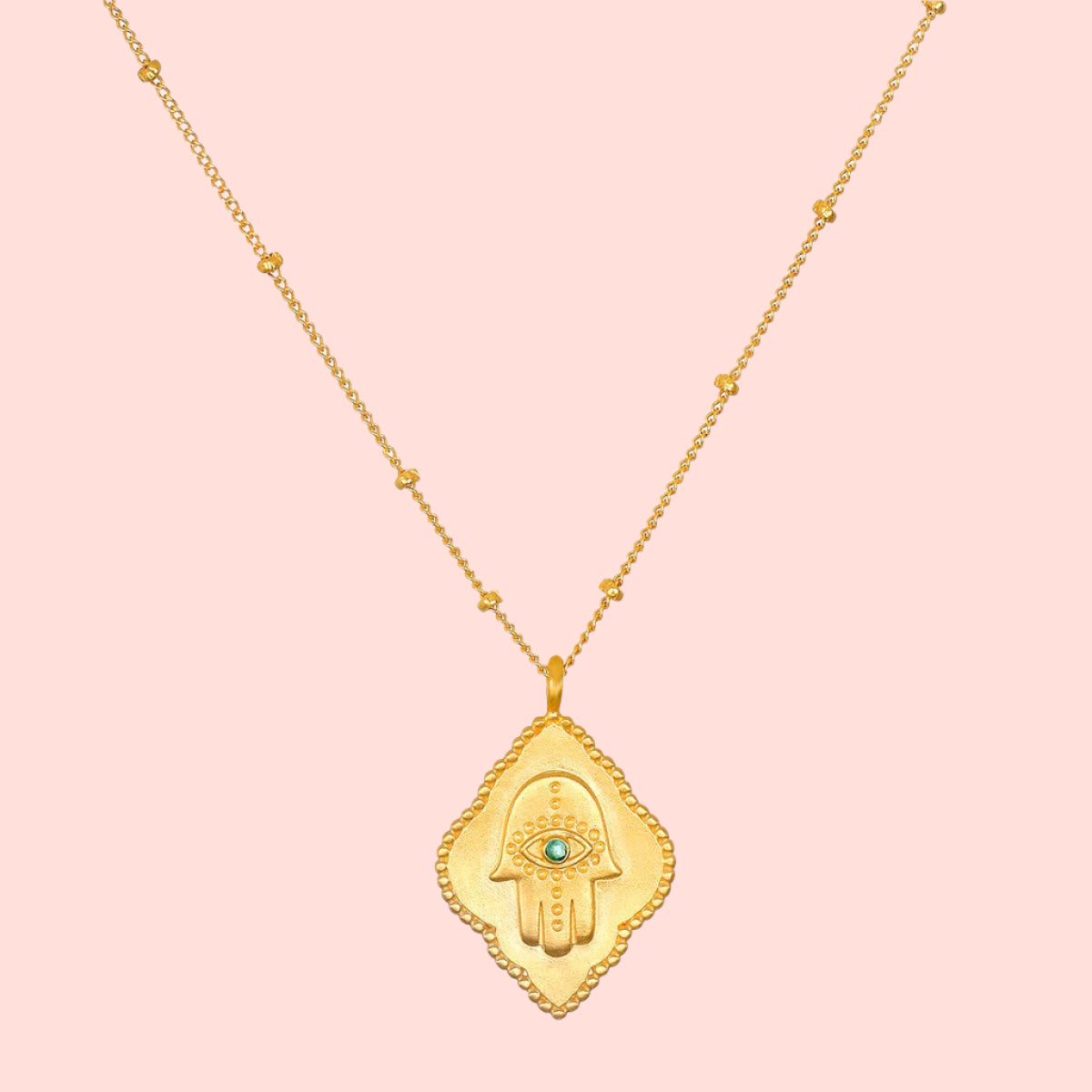 16" Emerald Hamsa Pendant Necklace with 3" extension chain features a Hamsa hand pendant adorned with an engraved eye and central emerald, hanging from a delicate beaded chain—a modern, elegant twist on the classic evil eye necklace.