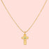 The 16" Emerald Dot Cross Pendant Necklace with a 3" extension features a beaded chain and a textured cross pendant accented by a small emerald, shown on a white background—a timeless piece of faith jewelry.