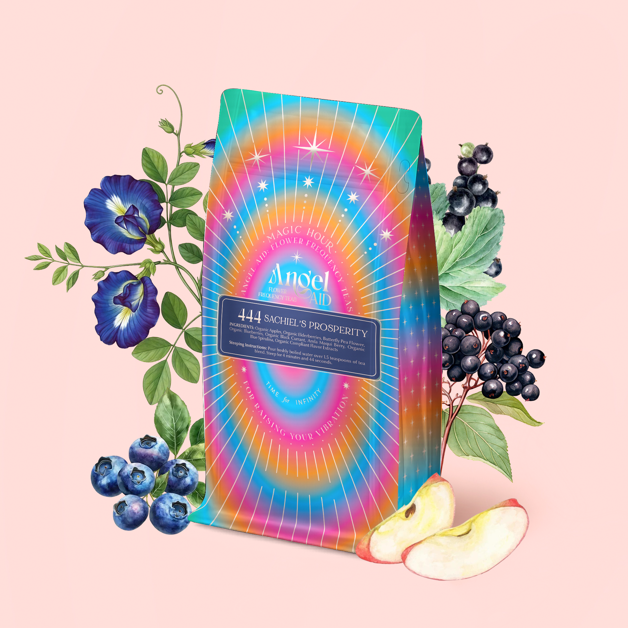 A vibrant tea package labeled "444: Sachiel's Prosperity" sits among blueberries, apple slices, black elderberries, and blue flowers—an eye-catching blue elixir of apple-berry herbal tea with butterfly pea flower and blue spirulina.