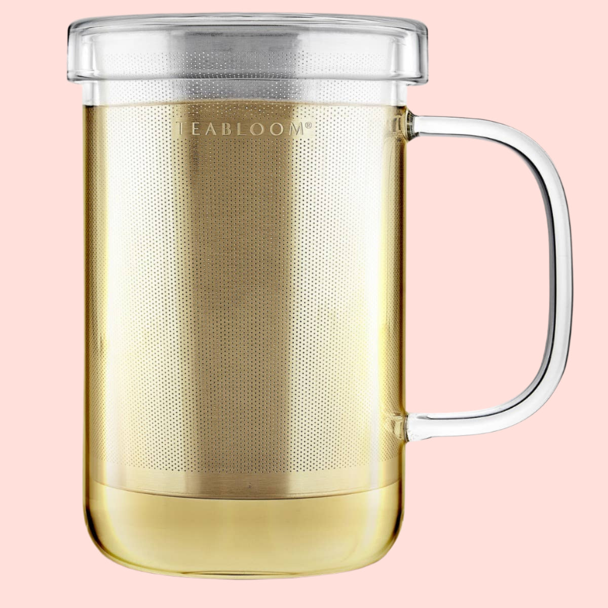 The Teabloom Balance Single-Serve Tea Maker (12 oz) is a clear borosilicate glass mug with a handle, transparent lid, and stainless steel infuser, partially filled with light-colored tea. "TEABLOOM" appears on the infuser.