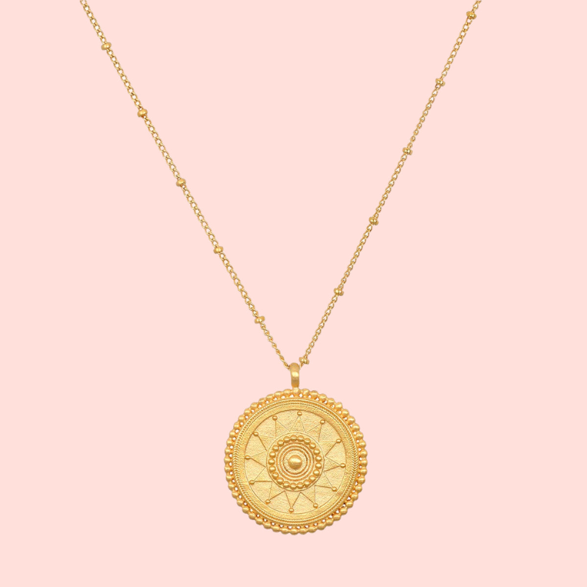 The 18" Sunburst Medallion Necklace is a gold-plated piece featuring a circular sun, moon, and star pendant—perfect for adding celestial charm to any look.