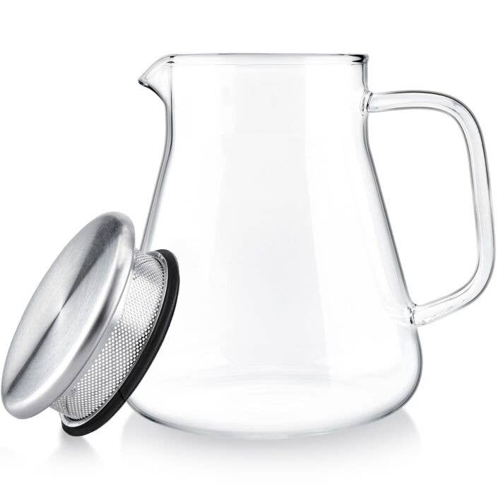 The Teabloom One-touch Tea Maker (15 oz/1-2 cups) features a clear glass carafe with handle and a round silver metal lid with built-in mesh strainer, showcased empty in a minimalist style against a white background.