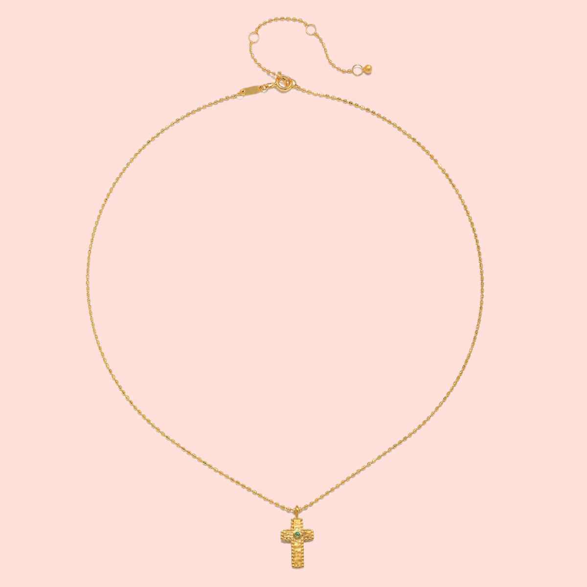 The 16" Emerald Dot Cross Pendant Necklace + 3" extension showcases a delicate gold cross with sparkling emerald accents, elegantly displayed on a plain white background—a timeless piece of faith jewelry.