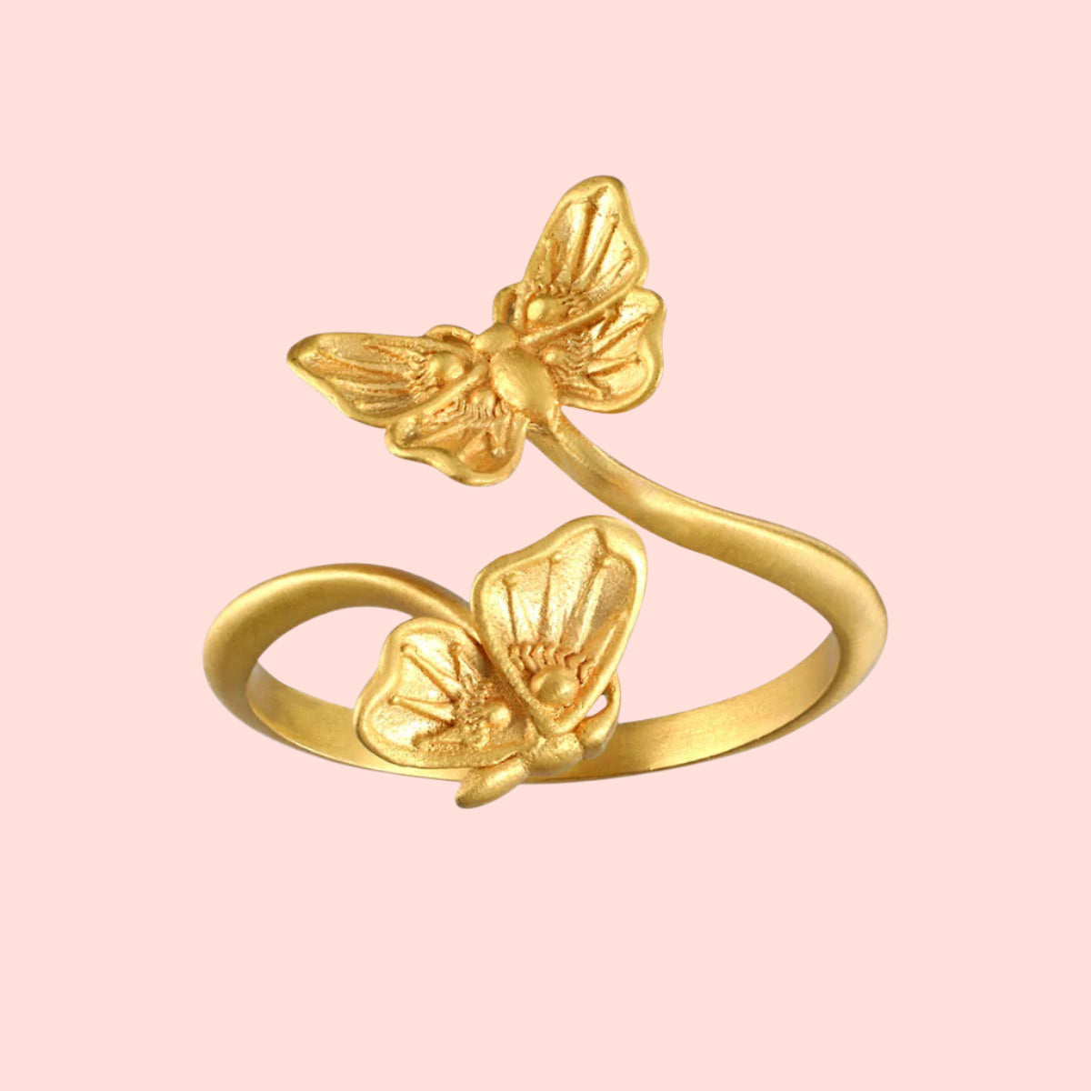 The Freedom to Soar Adjustable Butterfly Double Butterfly Ring showcases two detailed butterfly motifs facing each other on an open band, finished in radiant 18k gold plate for a stunning shine and a perfect adjustable fit.