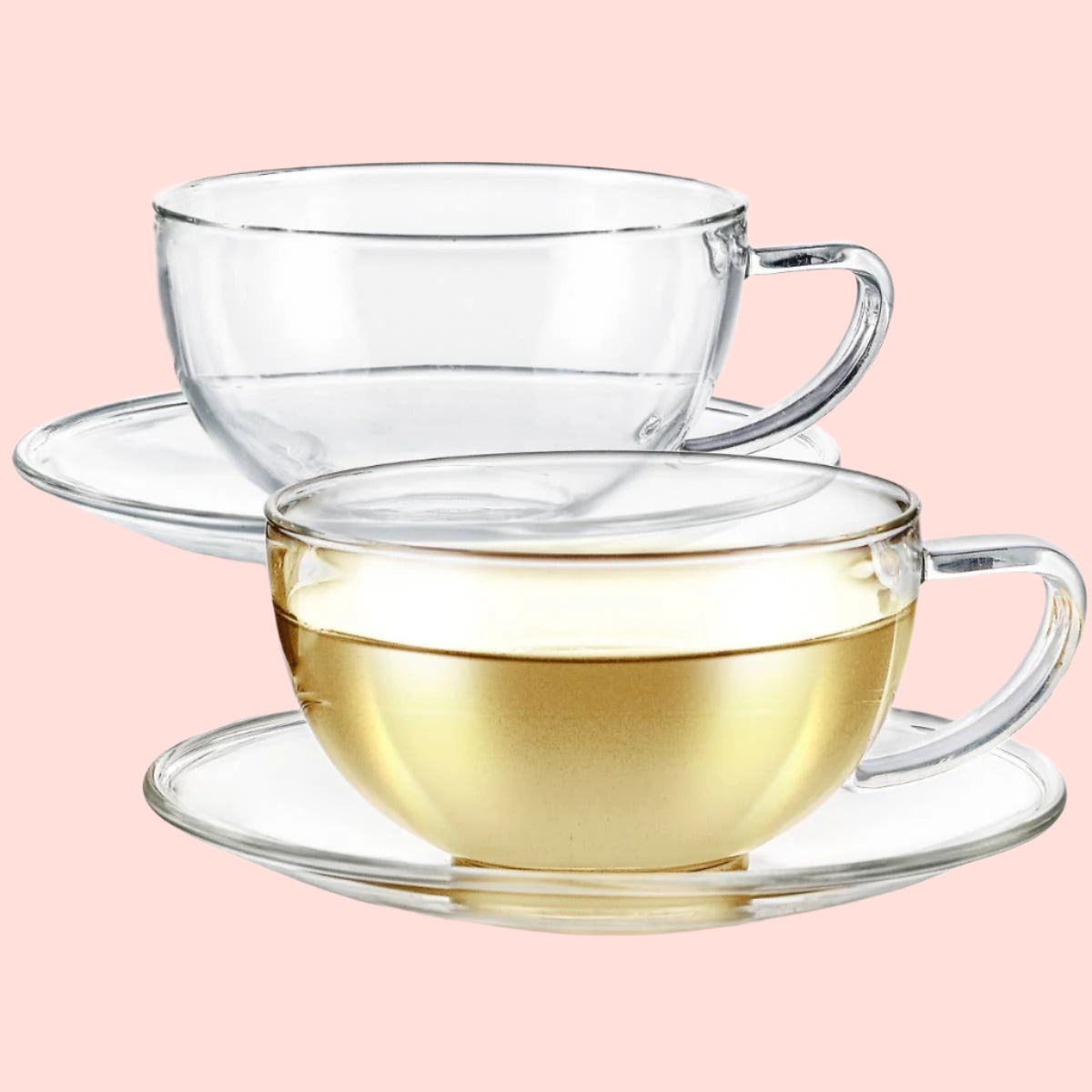 Two Teabloom Kyoto Tea Cup and Saucer Sets made of clear borosilicate glass sit side by side on a white background—one empty, one filled with light yellow tea for a premium-quality experience.