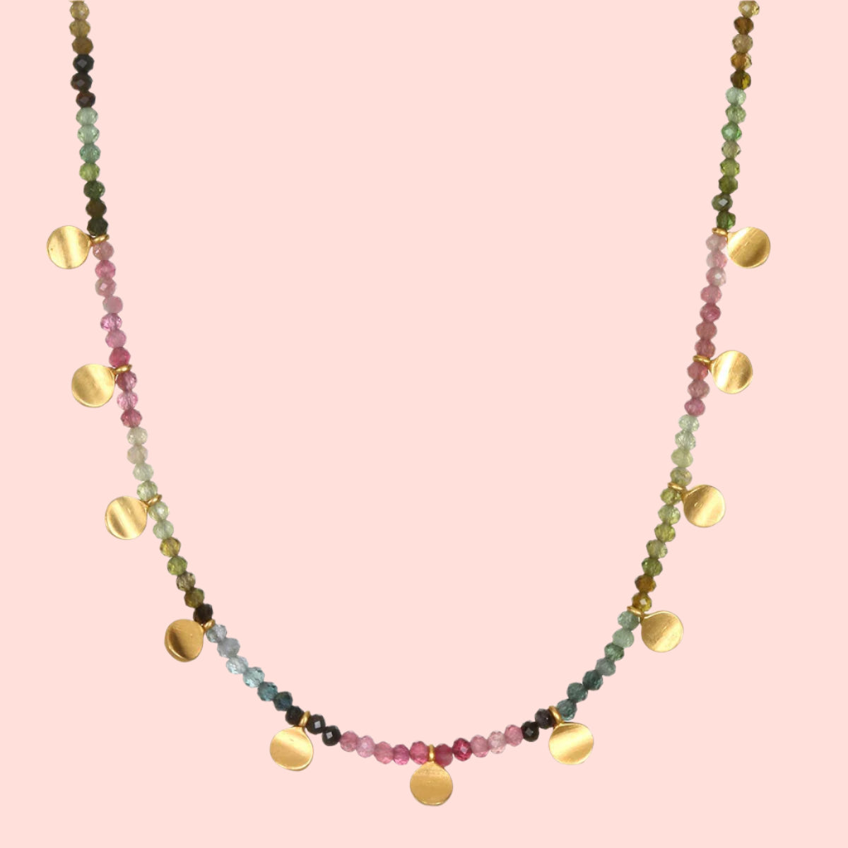 The Tourmaline Gold Moon Choker Necklace features multicolored pink, green, and blue tourmaline beads with round gold charms evenly spaced along the lower half.