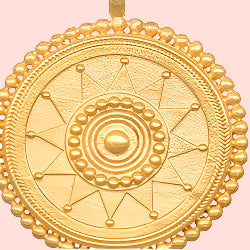 The 18&quot; Sunburst Medallion Necklace features a round gold plated pendant with geometric patterns, including concentric circles, triangles, and beaded detailing on the outer edge.