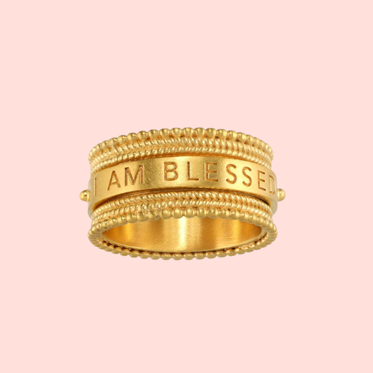 The Satya Jewelry Blessings Mantra Spinning Ring, plated in 18KT gold, features beaded edges and the engraved mantra "I AM BLESSED" on its smooth center band. Available in sizes 6, 7, and 8.