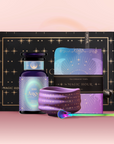 The Angel Numerology Fruit & Flower Tea Gift Set includes a black and gold starry box, purple “Angel” bottle, star-patterned cloth, blue-purple tea towel, and colorful spoon—all beautifully displayed on a pink background.