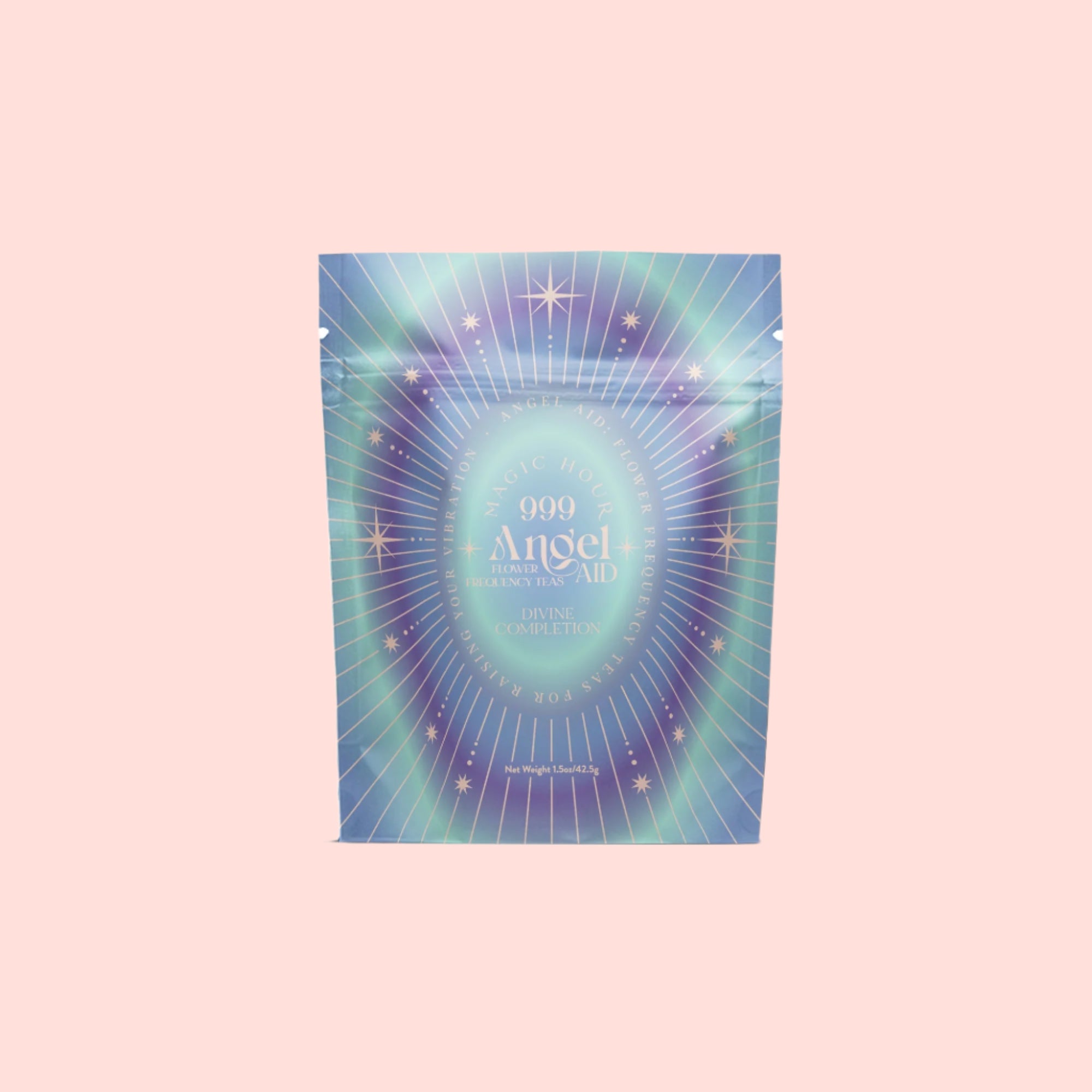 A pastel, holographic pouch labeled "999: Divine Completion" features radiating lines, star designs, and celestial-themed graphics, evoking spiritual completion against a light pink background.