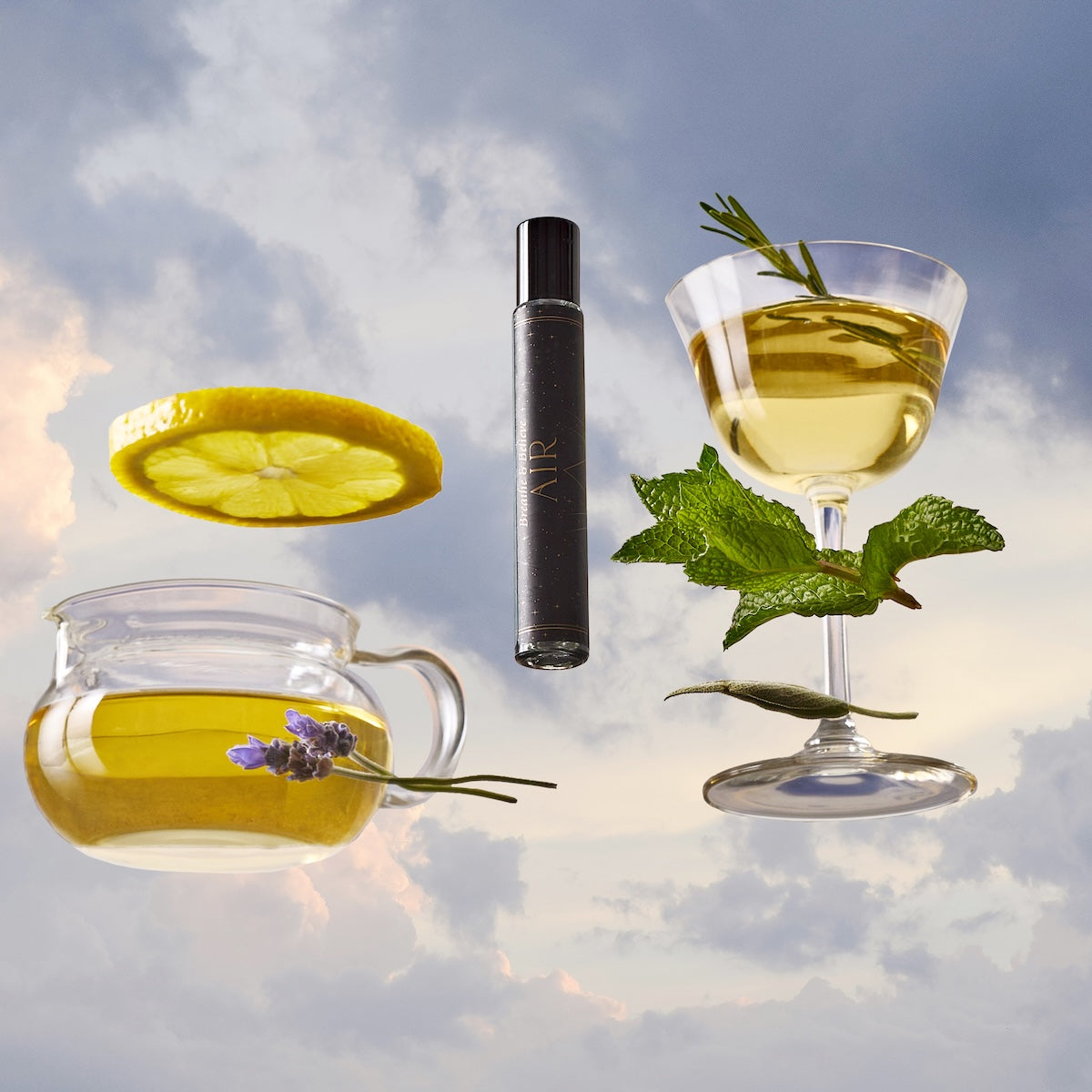 A glass teapot with herbal tea, a lavender sprig, lemon slice, fresh mint, rosemary, a glass of yellow drink, and the Air Essential Oil Perfume bottle float against a cloudy sky backdrop.