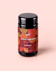 A black tea canister labeled “S’mores: Chocolate Herbal Dessert Tea for the Kid in All of Us,” featuring an orange and brown circular pattern on a light pink background, offers a cozy caffeine-free experience crafted with organic rooibos for a delightful herbal tea twist.