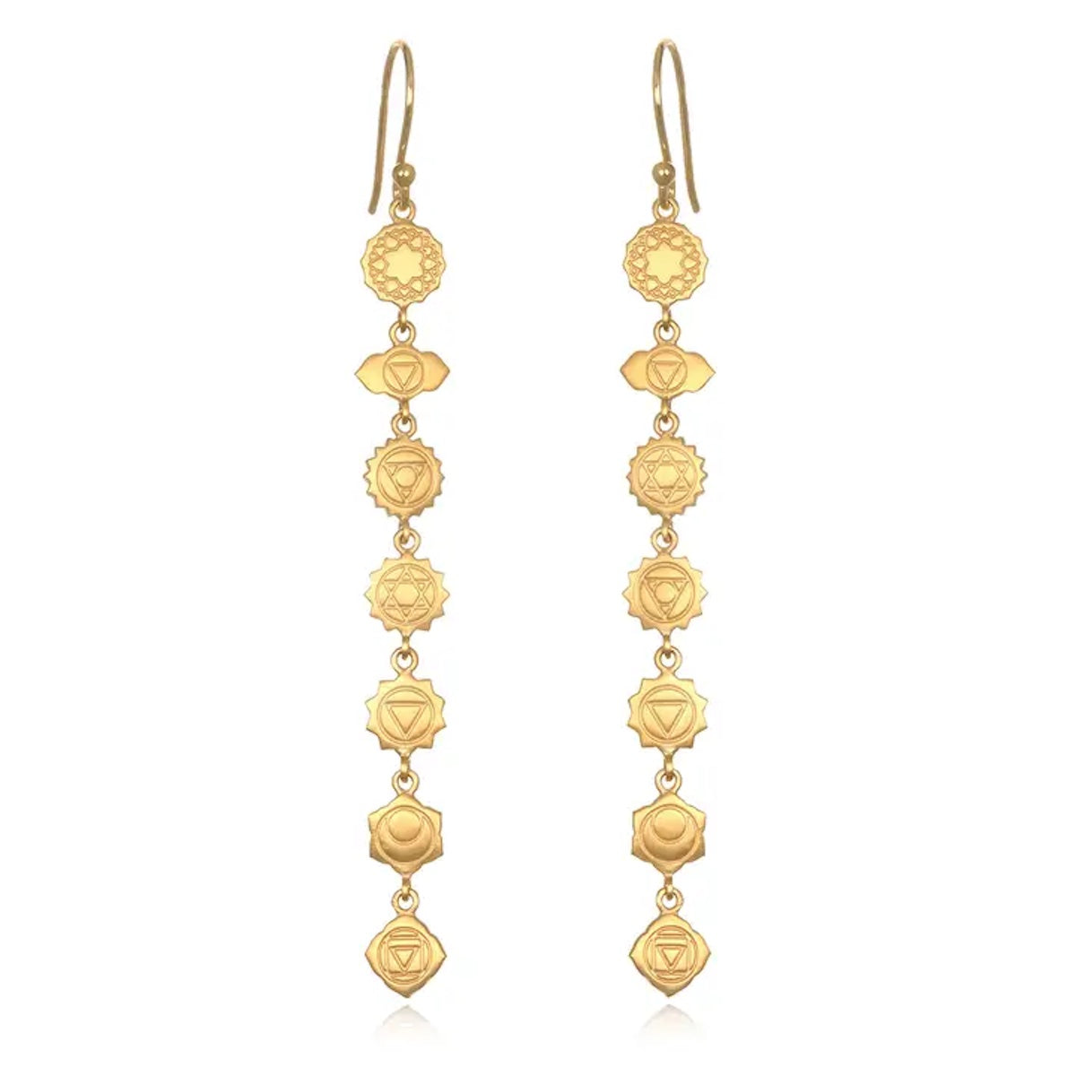 The Aligned in Harmony Earrings are a pair of 18kt gold-plated drop earrings featuring a series of intricately designed round and diamond shapes connected in a linear sequence. Each earring consists of seven connected elements, symbolizing the seven chakras, making fourteen elements in total for the pair. The design is elegantly symmetrical, embodying harmonious balance.