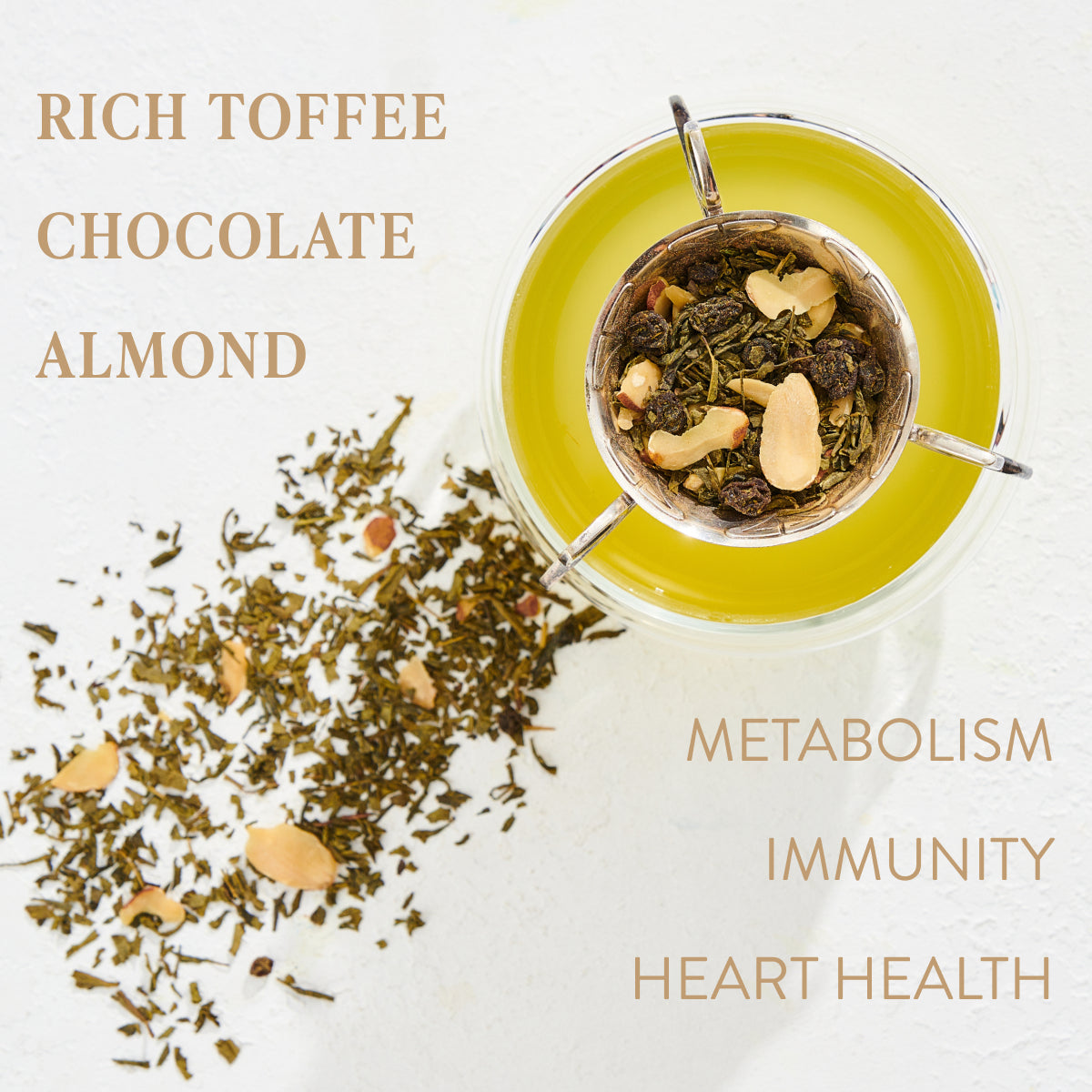 A cup of yellow-green tea on a white surface with loose leaf tea and almond pieces scattered around. Text on the image reads: &quot;Almond Matcha Green Tea for Joy&quot; and &quot;Metabolism, Immunity, Heart Health&quot;. Enjoy the benefits of Magic Hour organic tea.