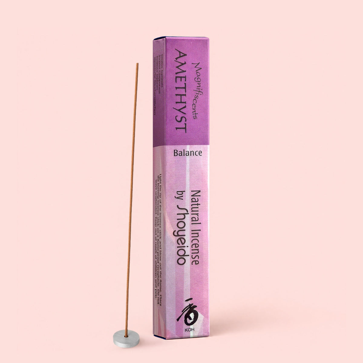 A box of Natural Incense : Amethyst, offering silky notes of sandalwood and cinnamon, stands upright next to a single incense stick in a small white holder, set against a light pink background.