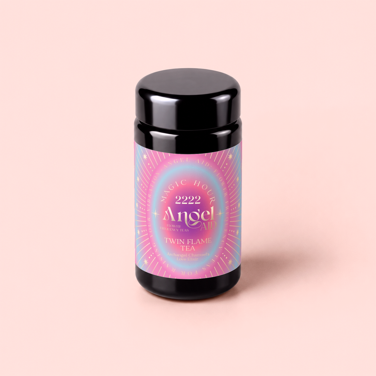 A black tea canister with a pink, blue, and gold label reading “Magic Hour 222: Hibiscus-Papaya Oolong with Roses,” set against a light pink background, invites you to experience a celestial rose blend tea.