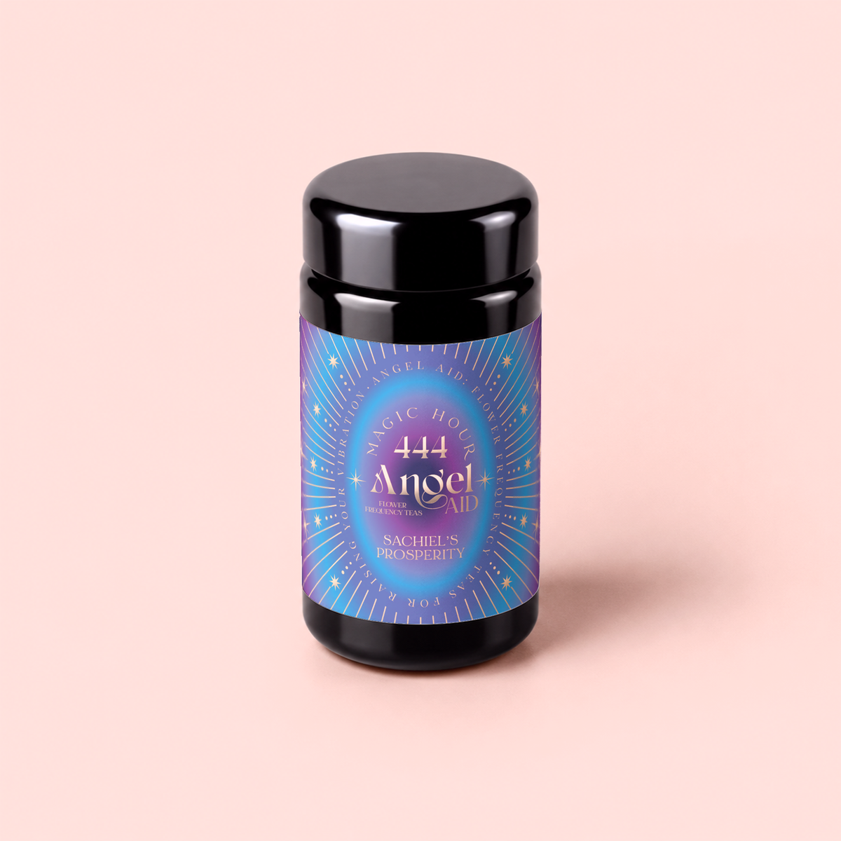 A black jar featuring a vibrant purple and blue label that reads “Magic Hour 444: Sachiel’s Prosperity Apple-Berry Herbal Tea with Butterfly Pea Flower and Blue Spirulina” sits against a light pink background, evoking the mystical energy of Angel Number 444 and the soothing qualities of Third Eye Chakra tea.