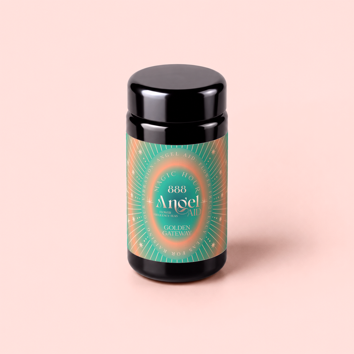 A black jar with a green and orange label reading “888: Lemon-Jasmine-Vanilla Herbal Tea”, “Magic Hour”, and “Golden Gateway” stands on a pale pink background, evoking the essence of abundance tea inspired by Archangel Michael.