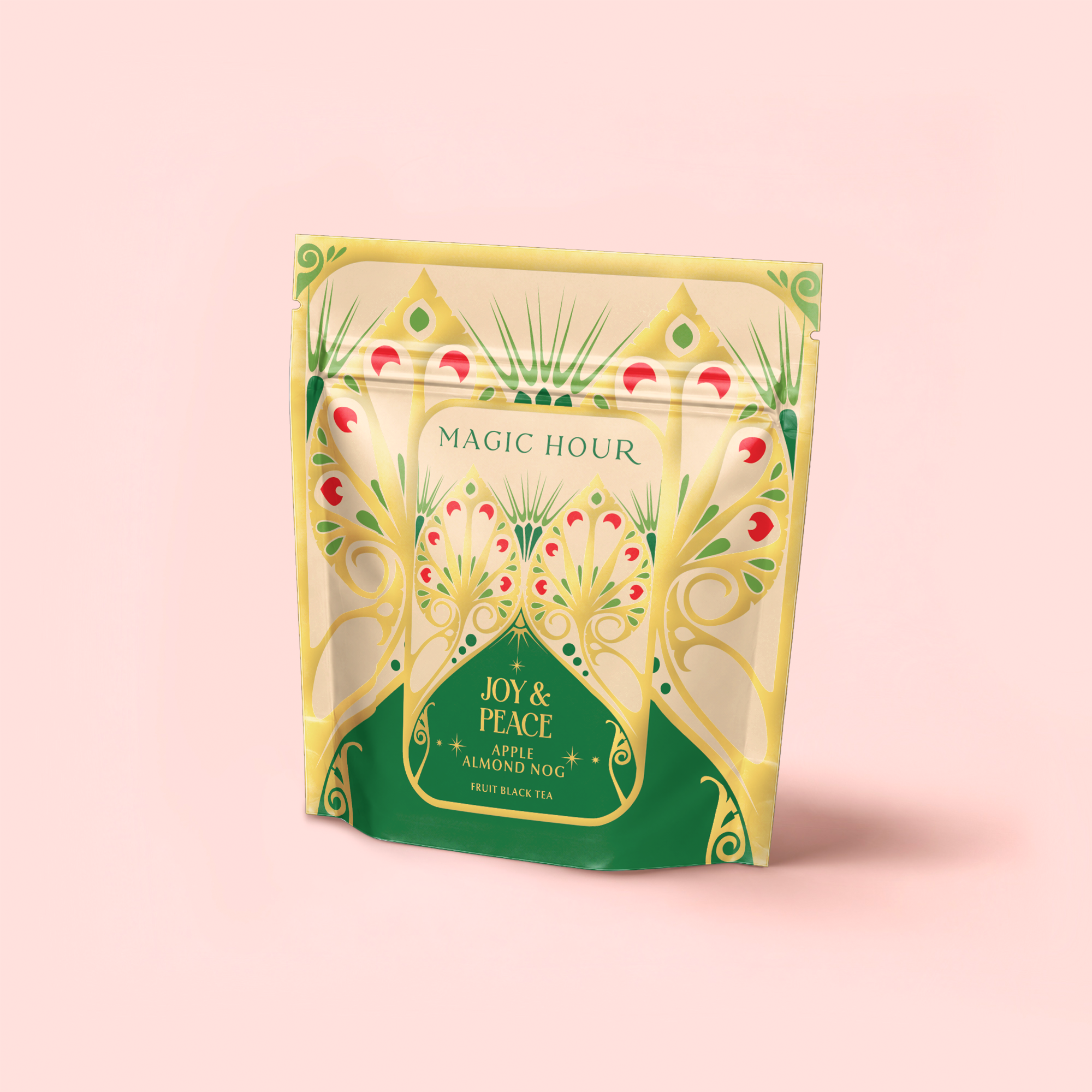 A yellow and green resealable pouch labeled “Apple Almond Nog” displays a festive, ornate design with peacock-like patterns on a pale pink background—an eggnog alternative tea that’s mood-boosting and delicious.